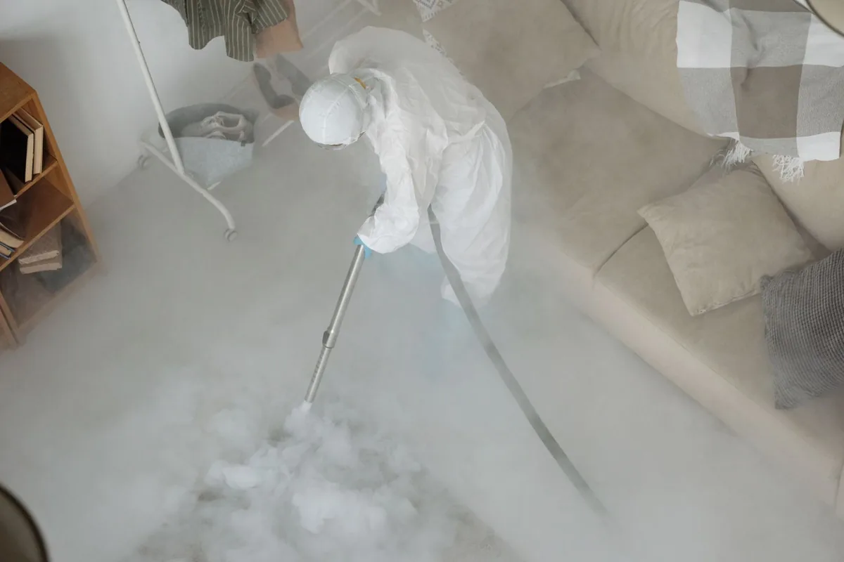 Biohazard cleanup technician in protective equipment, Henrietta, TX